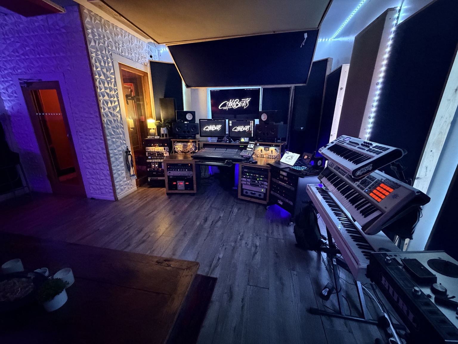 Chokobeats control room with keyboards, monitors, and recording equipment